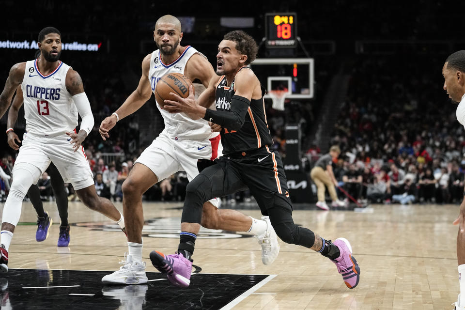 Atlanta Hawks guard Trae Young (11) drives against Los Angeles Clippers forward Nicolas Batum (33) during the second half of an NBA basketball game Saturday, Jan. 28, 2023, in Atlanta. (AP Photo/John Bazemore)