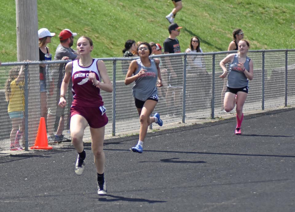 Union City's Addy Rumsey, winner of both the 200 meter dash and the long jump, leads her heat of the 200 down the stretch Saturday. Also pictured is race runner-up Jatziri Martinez of Coldwater.