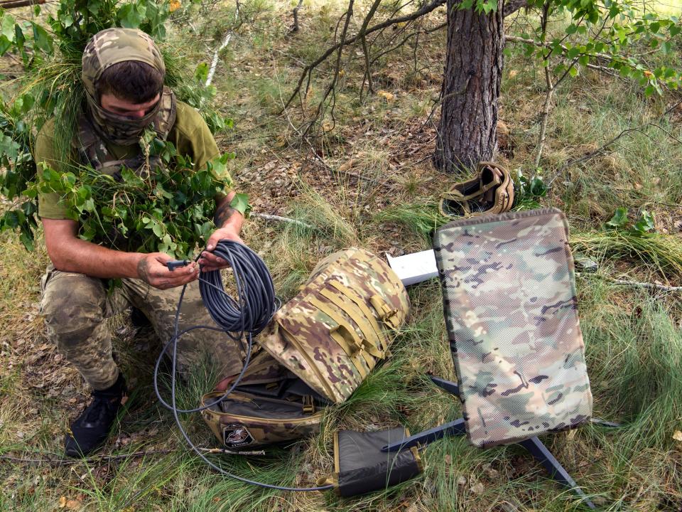 Soldier setting up a satellite.