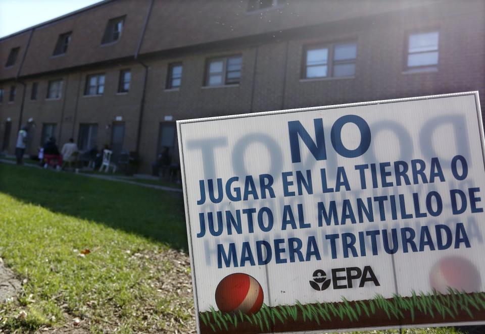 The West Calumet Housing Complex in East Chicago, Ind., was built on the site of an old lead refinery. It was closed down after children there were found to have elevated levels of lead in their blood. The sign reads: ‘Do not play in the dirt or next to shredded wood mulch.’ <a href="https://newsroom.ap.org/detail/LeadContaminationEastChicago/8d095ee761a64ca09dcb3e4a3baedfb7/photo" rel="nofollow noopener" target="_blank" data-ylk="slk:AP Photo/Tae-Gyun Kim;elm:context_link;itc:0;sec:content-canvas" class="link ">AP Photo/Tae-Gyun Kim</a>