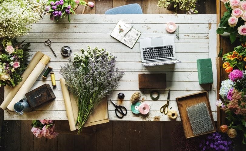 flowers and laptop on desk