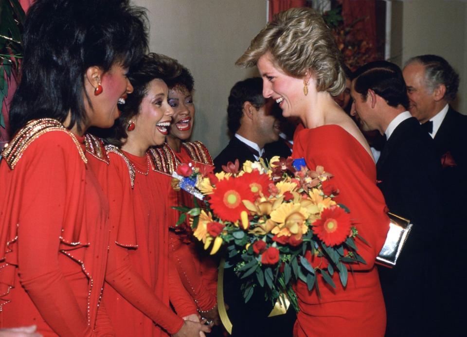 <p>All three members of singing group stunned in red long sleeve gowns, finished with gold sequins. It looks like Princess Diana got the memo, too.<br></p>