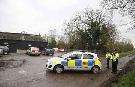 Police officers are seen outside a duck farm in Nafferton, northern England November 17, 2014. REUTERS/Phil Noble