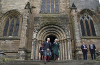 Britain's King Charles III and Camilla, the Queen Consort, leave Dunfermline Abbey, after a visit to mark its 950th anniversary, and after attending a meeting at the City Chambers in Dunfermline, Fife, where the King formally marked the conferral of city status on the former town. (Andrew Milligan/PA via AP)