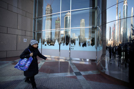 A woman walks outside an office building in Beijing's central business area, China, January 20, 2017. REUTERS/Jason Lee