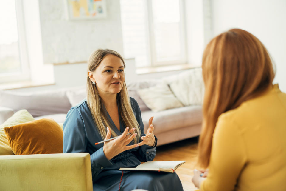 Two women sitting across from each other and talking