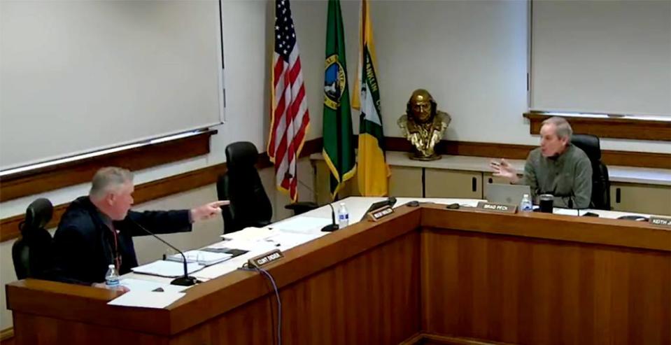 Franklin County Commissioner chairman Clint Didier, left, and commissioner Brad Peck have a contentious moment during an April 2022 meeting held in the courthouse meeting room in Pasco.