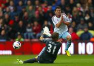 Southampton goalkeeper Artur Boruc saves a shot from West Ham United's Matthew Jarvis (rear)