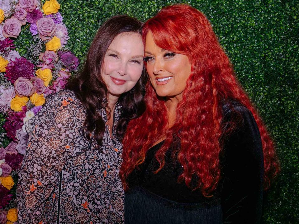 <p>Catherine Powell/Getty</p> Ashley Judd and Wynonna Judd seen backstage for CMT Coal Miner