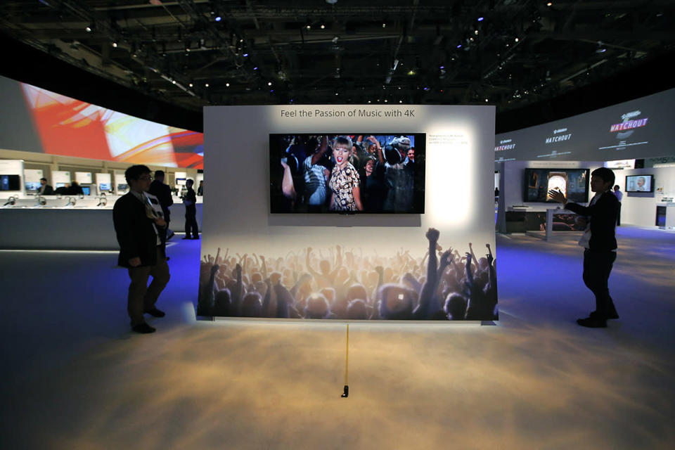 Technicians install Sony's 4k Ultra HD television at the Sony booth at the International Consumer Electronics Show.
