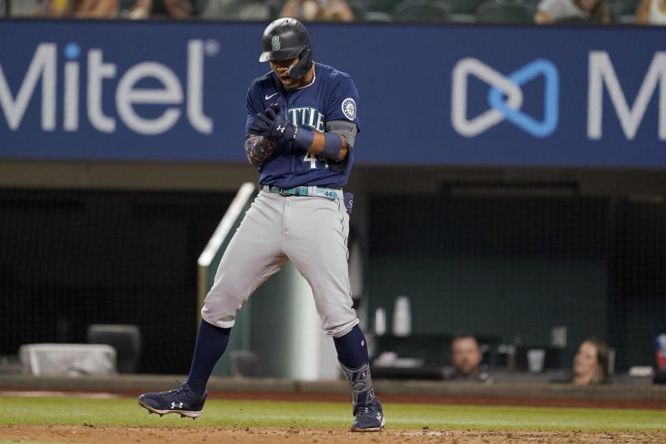 Seattle Mariners' Julio Rodriguez celebrates after he was hit by a pitch thrown by Texas Rangers' Dennis Santana with the bases loaded during the eighth inning of a baseball game Thursday, July 14, 2022, in Arlington, Texas. (AP Photo/Tony Gutierrez)