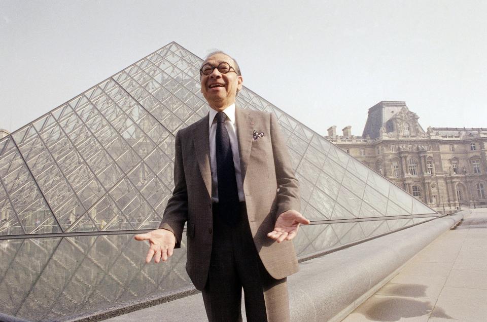 In this March 29, 1989, file photo, Chinese-American architect I.M. Pei laughs while posing for a portrait in front of the Louvre glass pyramid, which he designed, in the museum's Napoleon Courtyard, prior to its inauguration in Paris. Pei, the globe-trotting architect who revived the Louvre museum in Paris with a giant glass pyramid and captured the spirit of rebellion at the multi-shaped Rock and Roll Hall of Fame, has died at age 102, a spokesman confirmed Thursday, May 16, 2019. 