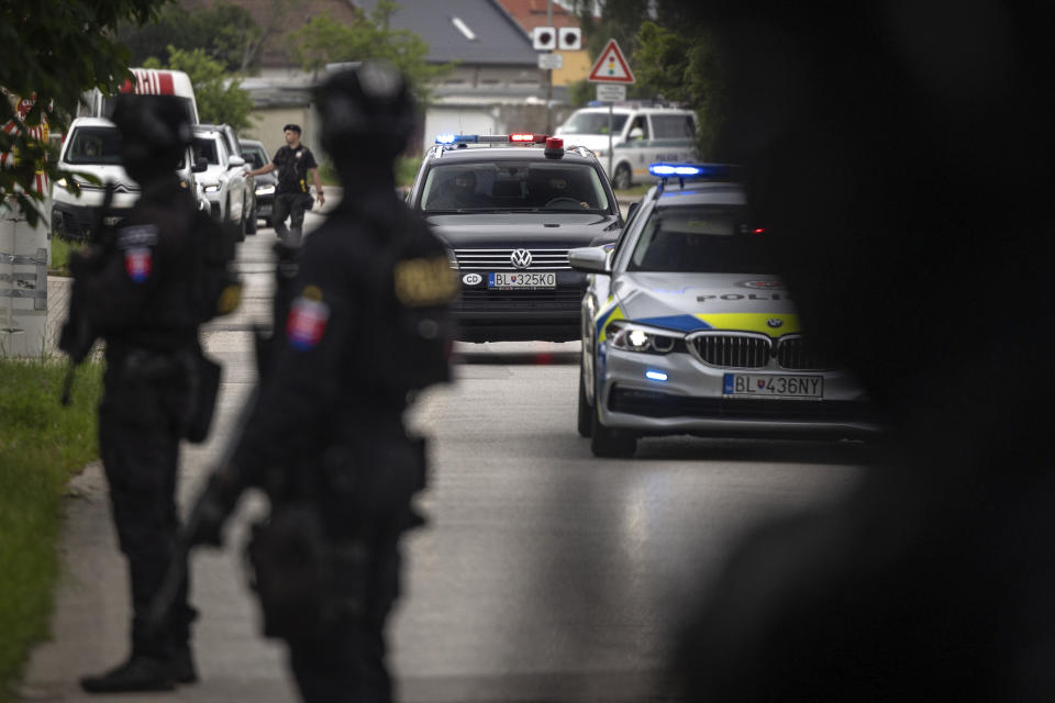 Policemen guard the area as convoy brings the suspect, in shooting of Slovakia's Prime Minister Robert Fico, to court in Pezinok, Slovakia, Saturday, May 18, 2024. Officials in Slovakia say Prime Minister Robert Fico has undergone another operation two days after his assassination attempt and remains in serious condition. (AP Photo/Tomas Benedikovic)