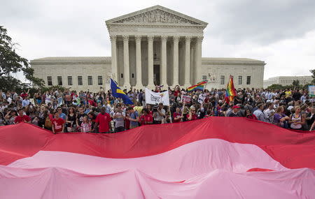 Supporters of gay marriage rally after the U.S. Supreme Court ruled on Friday that the U.S. Constitution provides same-sex couples the right to marry at the Supreme Court in Washington June 26, 2015. REUTERS/Joshua Roberts