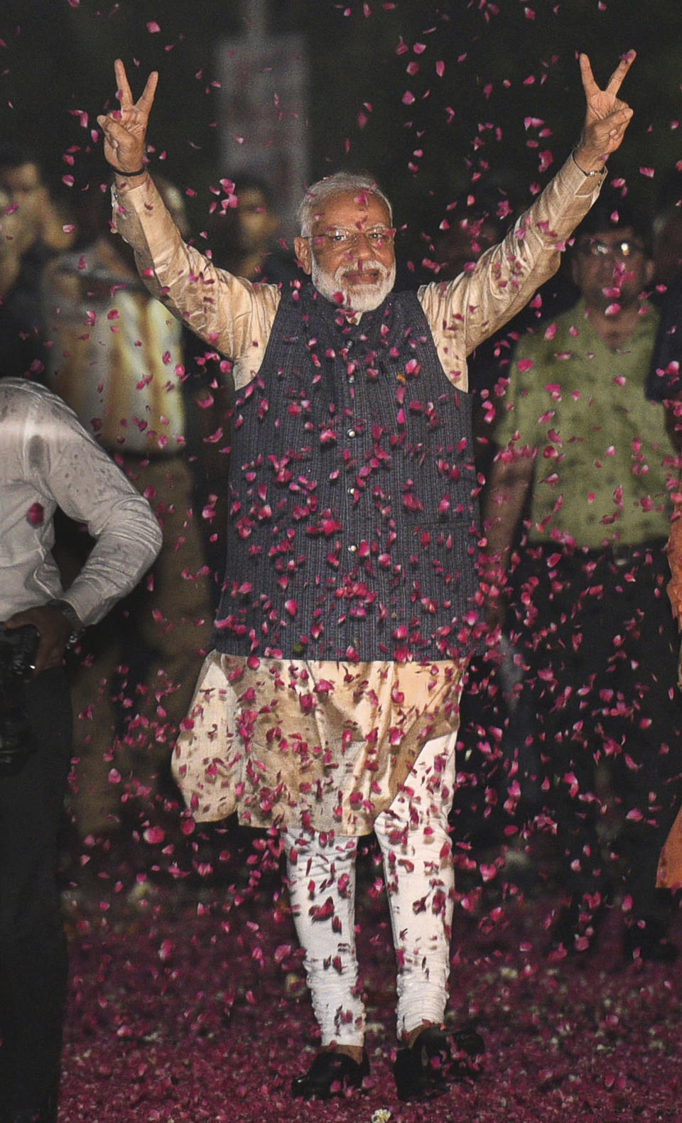 Indian Prime Minister Narendra Modi displays the victory symbol upon arrival at the party headquarters in New Delhi, India, Thursday, May 23, 2019. Modi's Hindu nationalist party claimed it won reelection with a commanding lead in Thursday's vote count, while the head of the main opposition party conceded a personal defeat that signaled the end of an era for modern India's main political dynasty. (AP Photo)