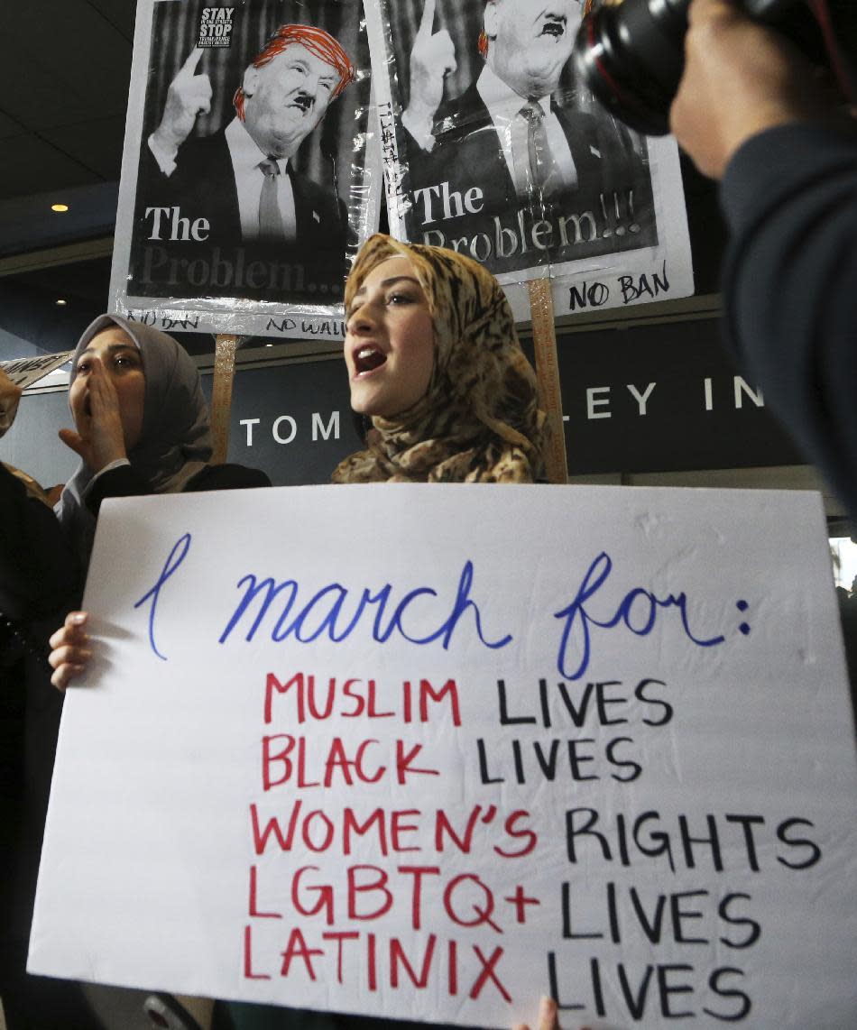 Women wearing traditional Muslim head coverings join demonstrators opposed to President Donald Trump's executive orders barring entry to the U.S. by Muslims from seven countries at the Tom Bradley International Terminal at Los Angeles International Airport on Saturday, Feb. 4, 2017. (AP Photo/Reed Saxon)