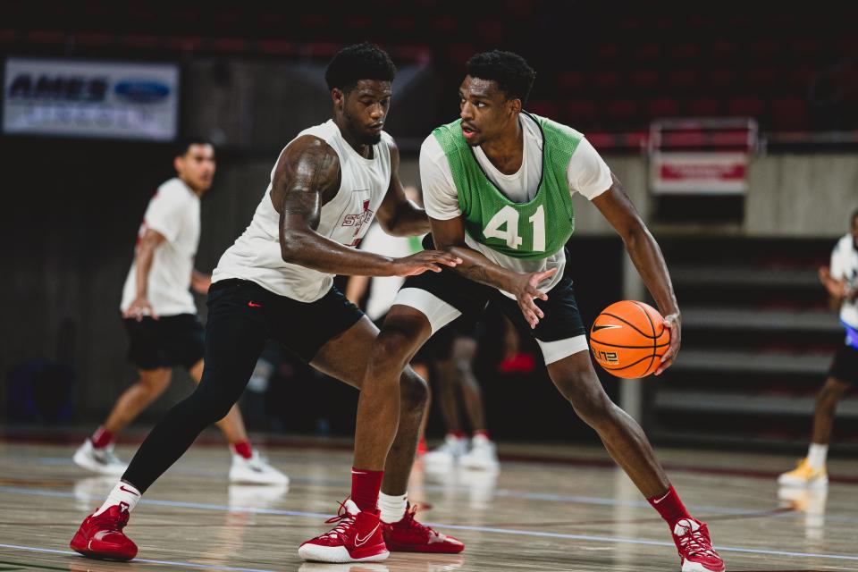 Iowa State 6-10 transfer Osun Osunniyi dribbles against Tre King during a summer workout.