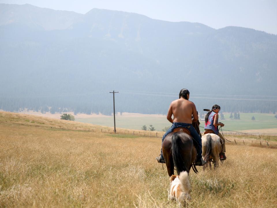 Leland Whiteplume and Farley Eagle Speaker ride horses on Am’sáaxpa or "the place of boulders," on Thursday, July 29, 2021 in Joseph, Ore.