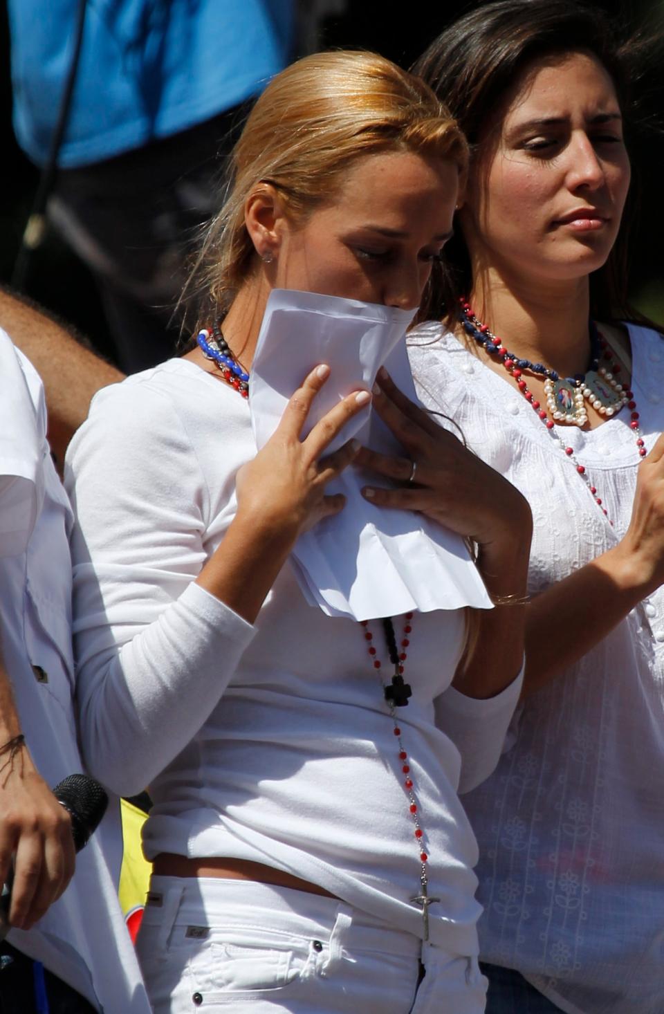 Lilian Tintori, wife of opposition leader Leopoldo Lopez, kisses a letter penned from jail by her husband, after reading it to supporters at an anti-government protest in Caracas, Venezuela, Saturday, March 22, 2014. The letter calls on the embattled Venezuelan President Nicolas Maduro to resign and open the door to national reconciliation. (AP Photo/Fernando Llano)