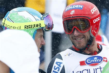 Bode Miller of the U.S. (R) speaks with compatriot Ted Ligety after the first run of the men's World Cup giant slalom race in St. Moritz February 2, 2014. REUTERS/Michaela Rehle