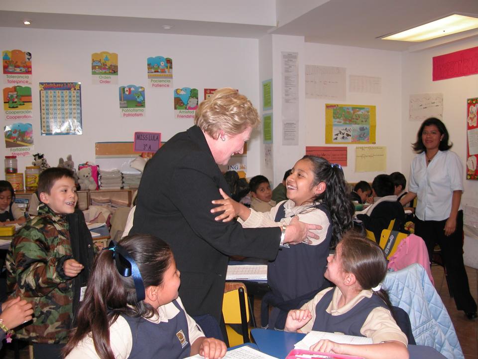 Christel DeHaan is greeted by students at the Christel House Mexico learning center in 2010.