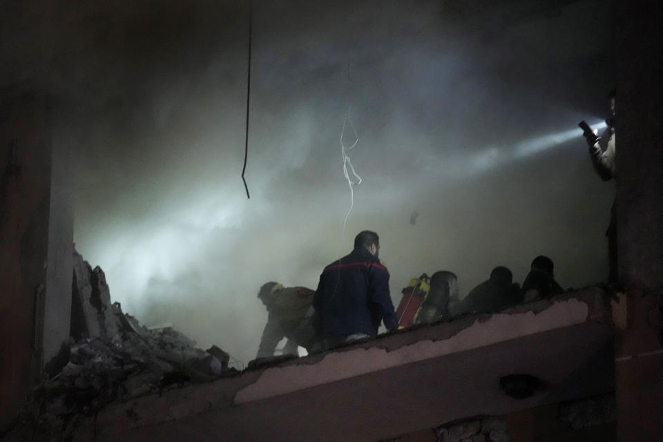 Civil defense workers search for survivors inside an apartment following a massive explosion in the southern suburb of Beirut, Lebanon, Tuesday, Jan. 2, 2024. The TV station of Lebanon's Hezbollah group says top Hamas official Saleh Arouri was killed Tuesday in an explosion in a southern Beirut suburb.(AP Photo/Hussein Malla)