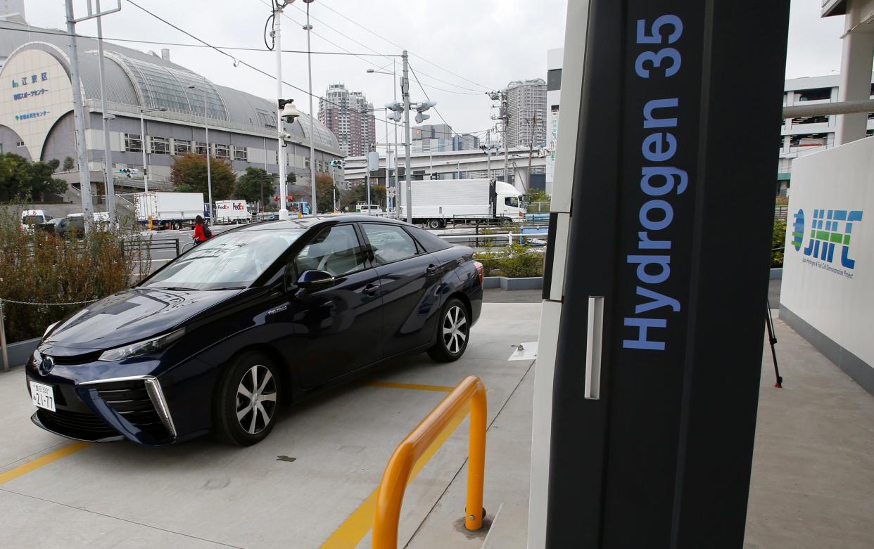 FILE - In this photo taken Nov. 17, 2014, a Toyota Motor Corp.'s new hydrogen fuel cell vehicle Mirai arrives at a charge station near Toyota's showroom in Tokyo. Four Rocky Mountain states announced plans Thursday, Feb. 24, 2022, to cooperate on making the most abundant element in the universe, hydrogen, more readily available and useful as fuel for cars, trucks and industry. (AP Photo/Shizuo Kambayashi, File)