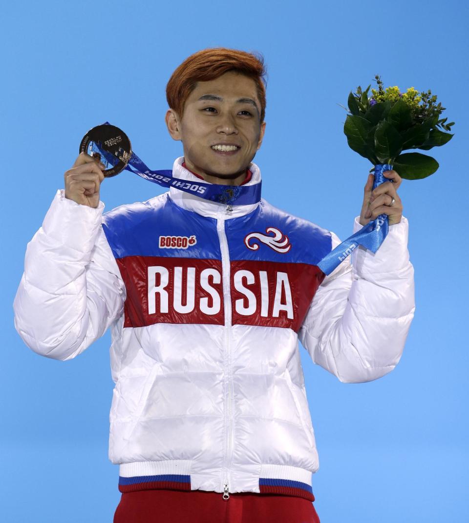 Viktor Ahn of Russia, who won the bronze medal in the men's 1,500-meter short track speedskating holds his medal during the medals ceremony at the 2014 Winter Olympics, Monday, Feb. 10, 2014, in Sochi, Russia. (AP Photo/Morry Gash)