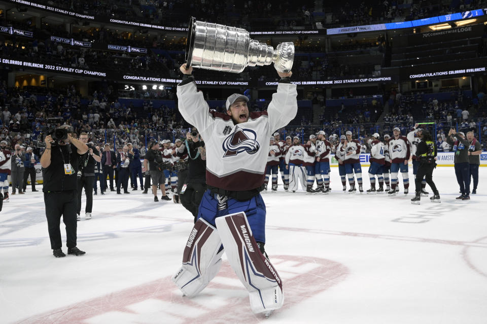 Colorado Avalanche goaltender Darcy Kuemper lifts the Stanley Cup after the team defeated the Tampa Bay Lightning in Game 6 of the NHL hockey Stanley Cup Finals on Sunday, June 26, 2022, in Tampa, Fla. (AP Photo/Phelan M. Ebenhack)