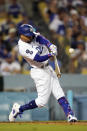 Los Angeles Dodgers' Mookie Betts connects for a double during the third inning of a baseball game against the Colorado Rockies Saturday, Oct. 1, 2022, in Los Angeles. (AP Photo/Marcio Jose Sanchez)