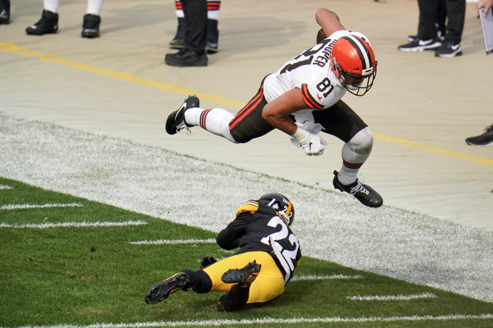 Cleveland Browns tight end Austin Hooper (81) hurdles over Pittsburgh Steelers cornerback Steven Nelson (22) while trying for more yards during the first half of an NFL football game, Sunday, Oct. 18, 2020, in Pittsburgh. (AP Photo/Gene J. Puskar)