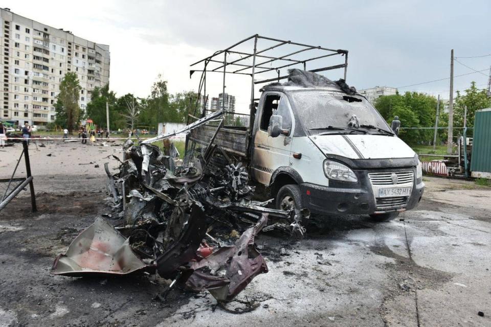 A white van is completely destroyed by a Russian glide bomb attack in Kharkiv, as a building seen behind has its windows blown out (Telegram)