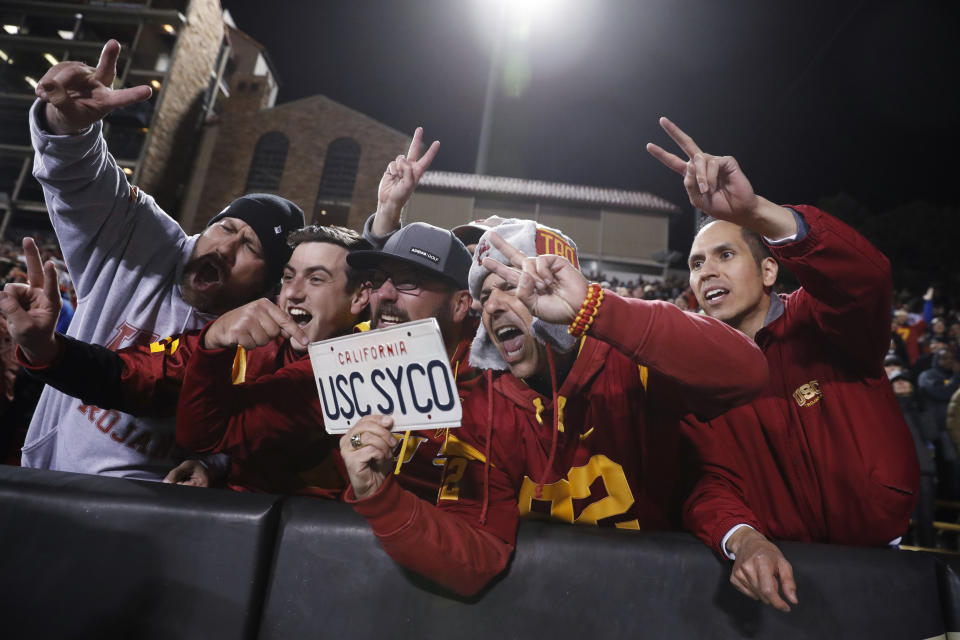 FILE - Southern California fans celebrate late in the second half of the team's NCAA college football game against Colorado on Friday, Oct. 25, 2019, in Boulder, Colo. Southern California won 35-31. College sports and the traveling fan are on course for a big reset in 2024. TV money has lured Southern Cal, UCLA, Oregon and Washington to the Big Ten. Arizona, Arizona State, Colorado and Utah will further add to the growing Big 12. And Oklahoma and Texas will debut in the Southeastern Conference. Although a few regional rivalries have been created or preserved, longer trips will be the norm. (AP Photo/David Zalubowski, File)