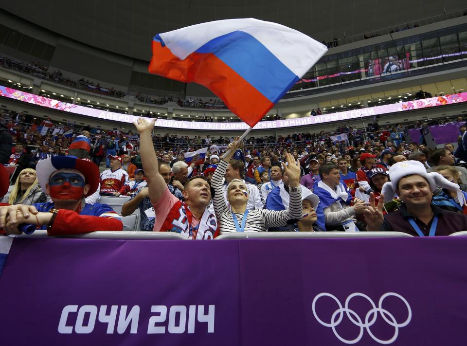 Russian fans cheer during the men's preliminary round ice hockey game between Team USA and Russia at the 2014 Sochi Winter Olympics, February 15, 2014. REUTERS/Jim Young (RUSSIA - Tags: OLYMPICS SPORT ICE HOCKEY)