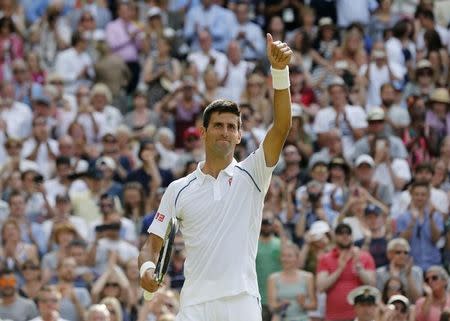 Novak Djokovic of Serbia celebrates after winning his match against Bernard Tomic of Australia at the Wimbledon Tennis Championships in London, July 3, 2015. REUTERS/Suzanne Plunkett