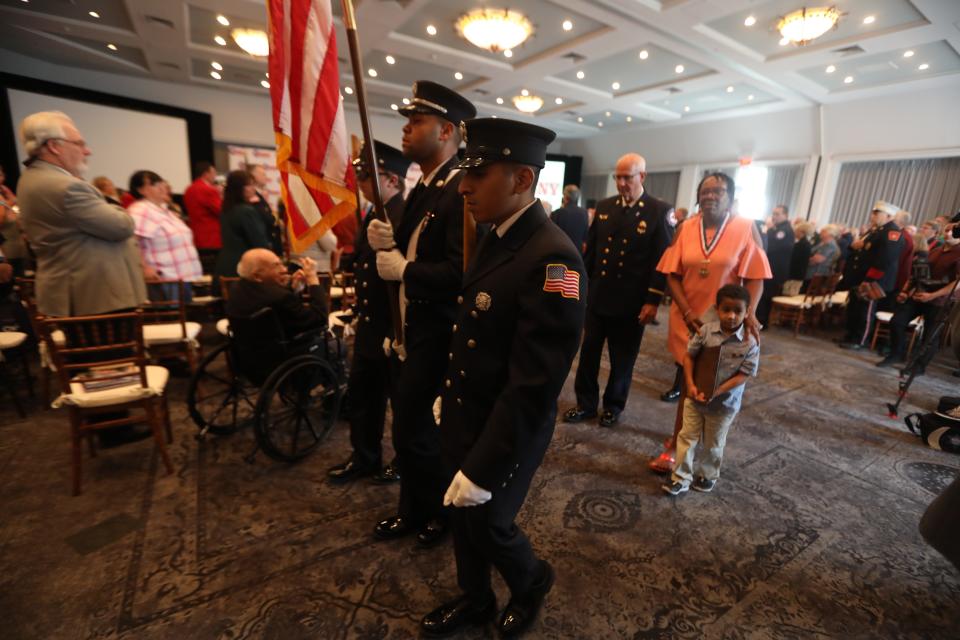 Sabrail Davenport, the mother of Jared Lloyd, the Spring Valley firefighter who died in the line of duty in 2021, and LloydÕs son Darius, 5, follow an honor guard after Lloyd was honored posthumously as the firefighter of the year during the Firefighters Association of New YorkÕs 150th annual convention at the Tarrytown House Estate Aug. 10 2022. Lloyd died March 23, 2021 as he tried to rescue residents in a massive fire at Evergreen Court Home For Adults in Spring Valley.