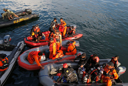 Rescuers operate rubber boats during a search and rescue operation for missing passengers from Monday's ferry accident at Lake Toba at Tigaras port in Simalungun, North Sumatra, Indonesia, June 21, 2018. REUTERS/Beawiharta