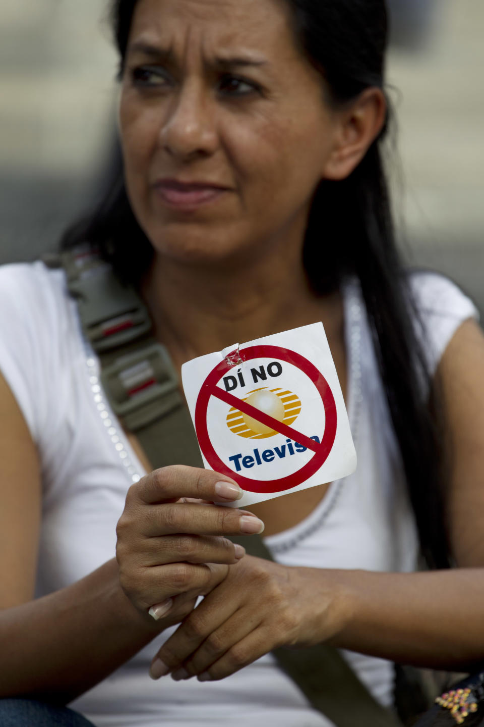 A woman holds a sign during a demonstration to protest a possible return of the old ruling Institutional Revolutionary Party (PRI) and against what is perceived as a biased coverage by major Mexican TV networks directed in favor of PRI's candidate Enrique Pena Nieto in Mexico City, Wednesday, May 23, 2012. Mexico will hold presidential elections on July 1. The sticker reads in Spanish: "Say No to Televisa". (AP Photo/Eduardo Verdugo)