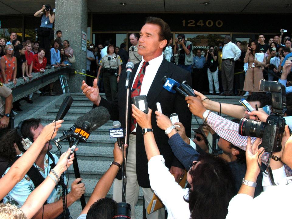 Arnold Schwarzenegger at the Los Angeles Registrar's office in Norwalk, California, talking to reporters.