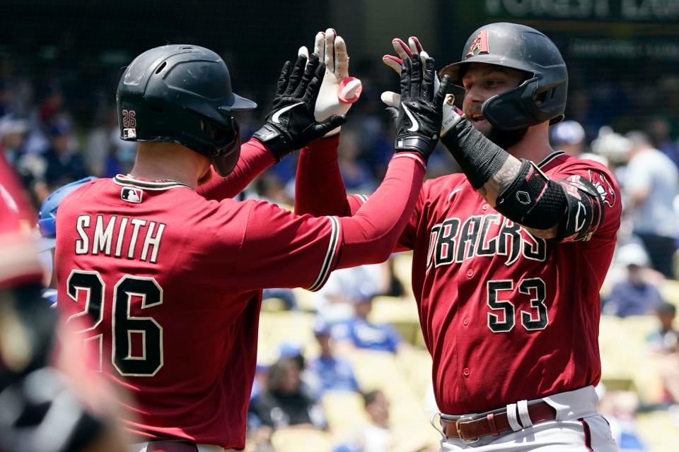 Arizona Diamondbacks' Christian Walker (53) celebrates his two-run home run with Pavin Smith (26) during the third inning of the first game of a baseball double-header against the Los Angeles Dodgers Tuesday, May 17, 2022, in Los Angeles. (AP Photo/Marcio Jose Sanchez)