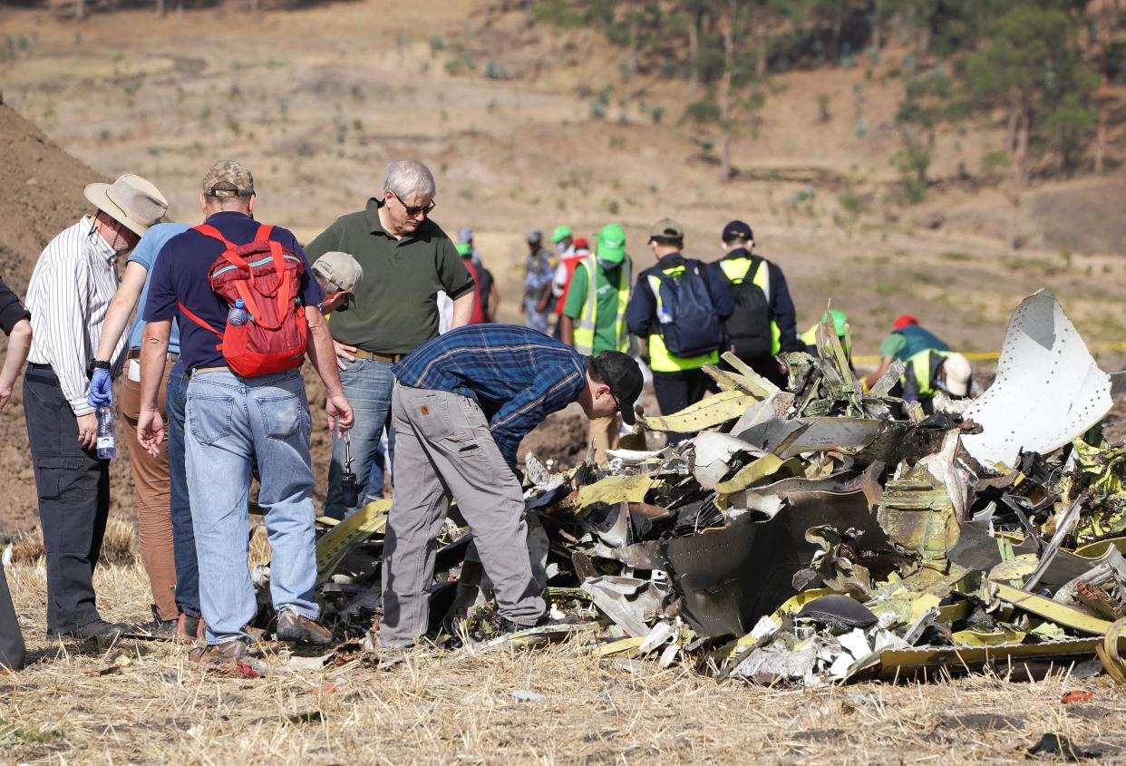 A group of investigators look over the debris left by a 2019 Boeing 737 MAX crash.