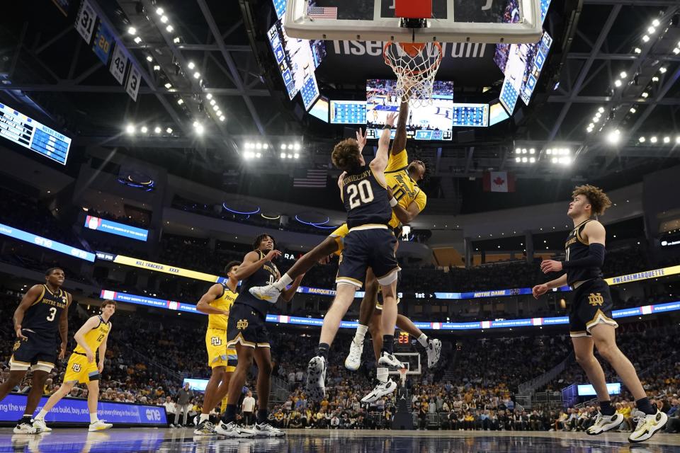 Marquette's Zaide Lowery shoots past Notre Dame's J.R. Konieczny during the first half of an NCAA college basketball game Saturday, Dec. 9, 2023, in Milwaukee. (AP Photo/Morry Gash)