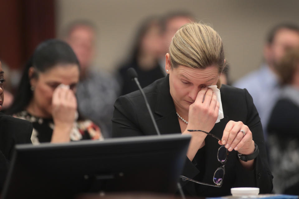 Gina Nichols, mother of victim Maggie Nichols, and Assistant Attorney General Angela Povilaitis wipe tears from their eyes as they listen to Gwen Anderson deliver a victim impact statement. (Photo: Scott Olson/Getty Images)