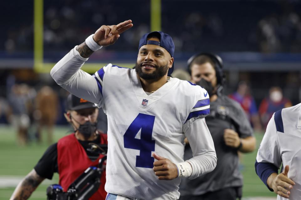 Dallas Cowboys quarterback Dak Prescott (4) acknowledges fans as he jogs off the field after their NFL football game against the Philadelphia Eagles in Arlington, Texas, Monday, Sept. 27, 2021. (AP Photo/Ron Jenkins)