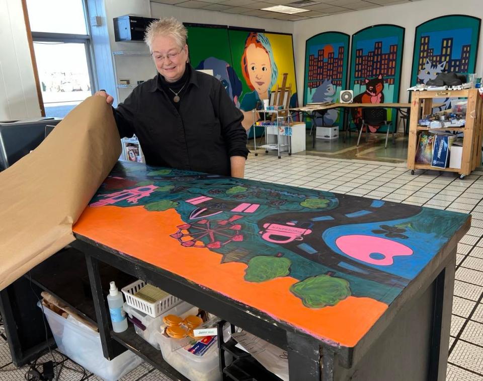 Artist Vicki Boatright looks at a mural she painted at the new Canton Creator Space in downtown Canton. Boatright  of BZTAT Studios is site manager and Neil Weakland is owner and operator of Canton Creator Space.