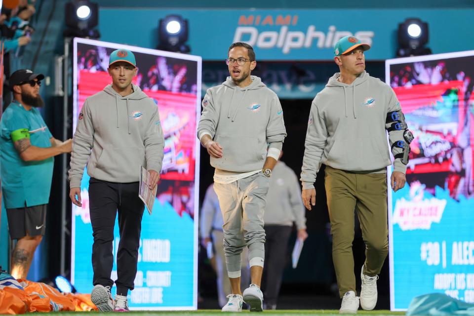 Dec 11, 2023; Miami Gardens, Florida, USA; Miami Dolphins head coach Mike McDaniel takes to the field for the game against the Tennessee Titans at Hard Rock Stadium. At right is Dolphins chief of security Drew Brooks.