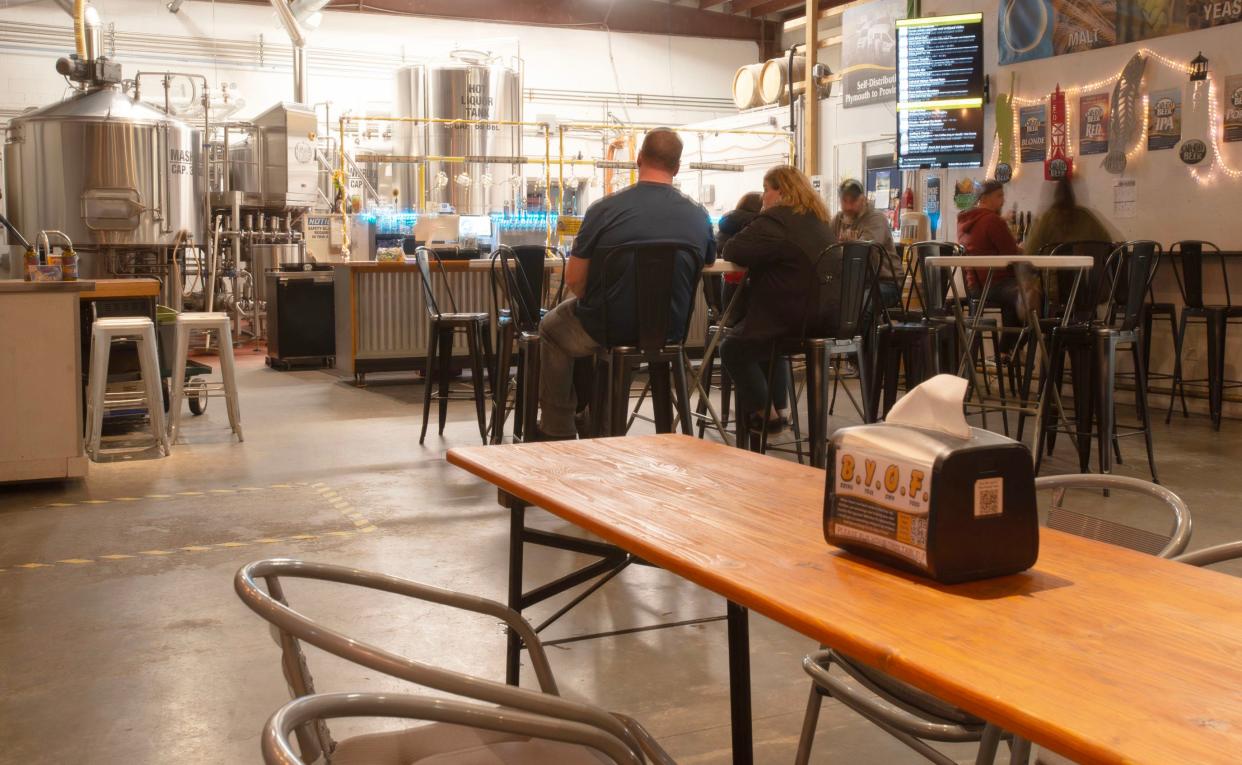 Patrons enjoy an afternoon beverage in the Cape Cod Beer tap room. The popular brewery is celebrating its 20th anniversary this year.