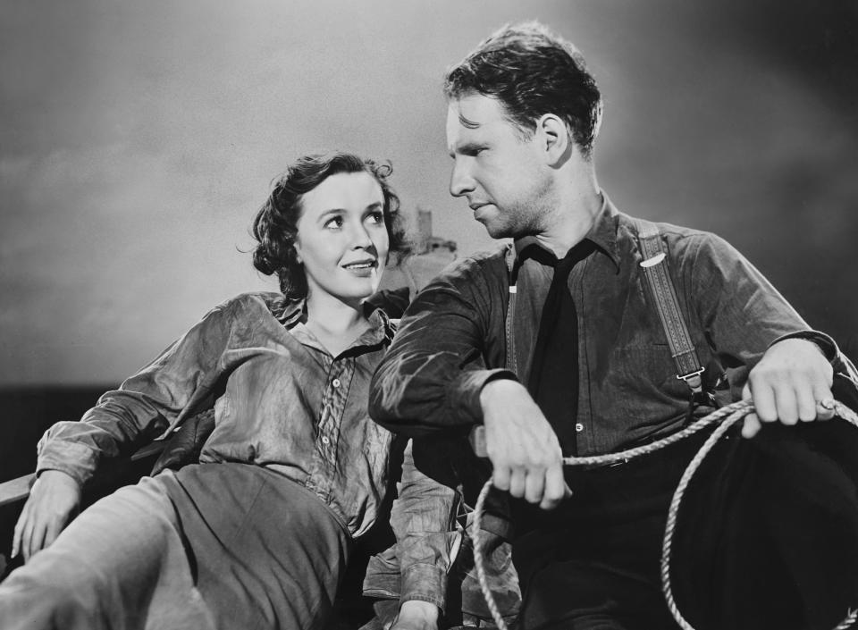 Mary Anderson and Hume Cronyn sitting in a lifeboat.