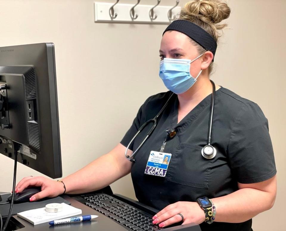 CoxHealth Certified Clinical Medical Assistant Darrien Gardner enters patient information into a computer at the Cox Medical Center in Branson Thursday, April 7.