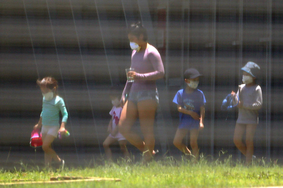 Evacuees are seen in the Christmas Island Australian Immigration Detention Centre on Friday. There is no suggestion any of these children have coronavirus. Source: AAP